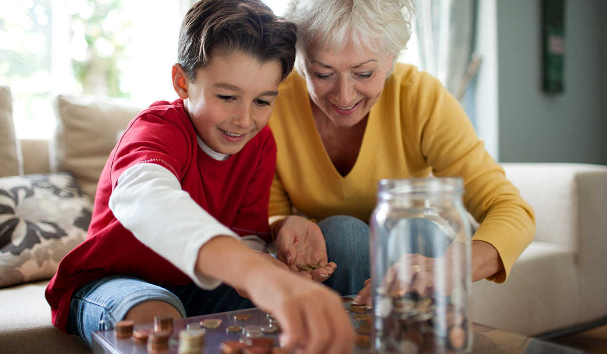 Grandmother Teaching Grandson About Money - Xact Loans