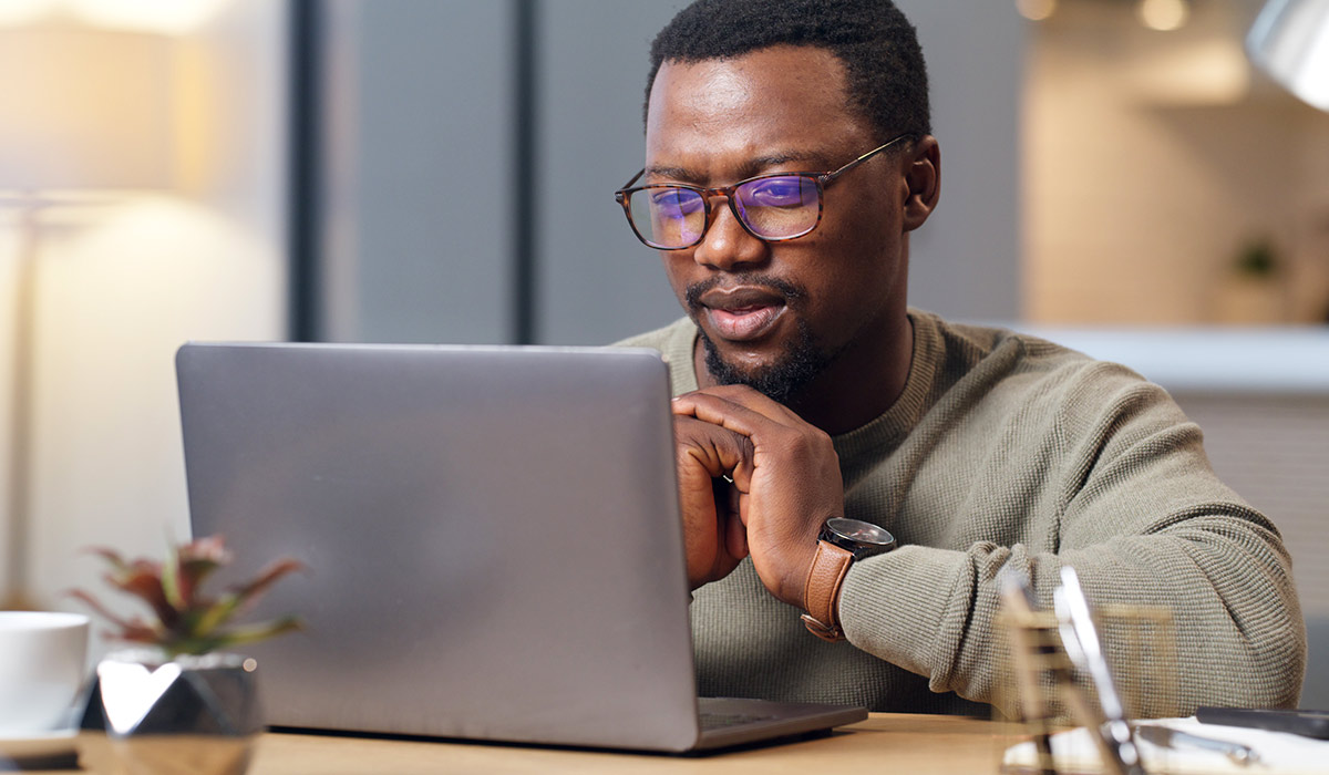 Man Studying Laptop Screen - Xact Loans
