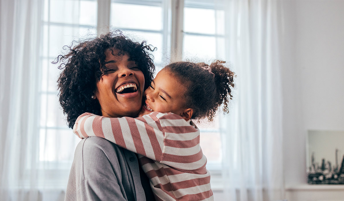 Mother and Daughter Hugging - Xact Loans
