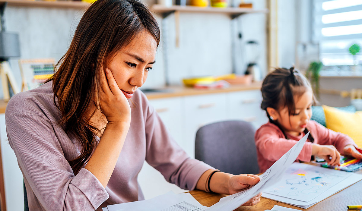 Mother Working on Her Budget with Daughter - Xact Loans