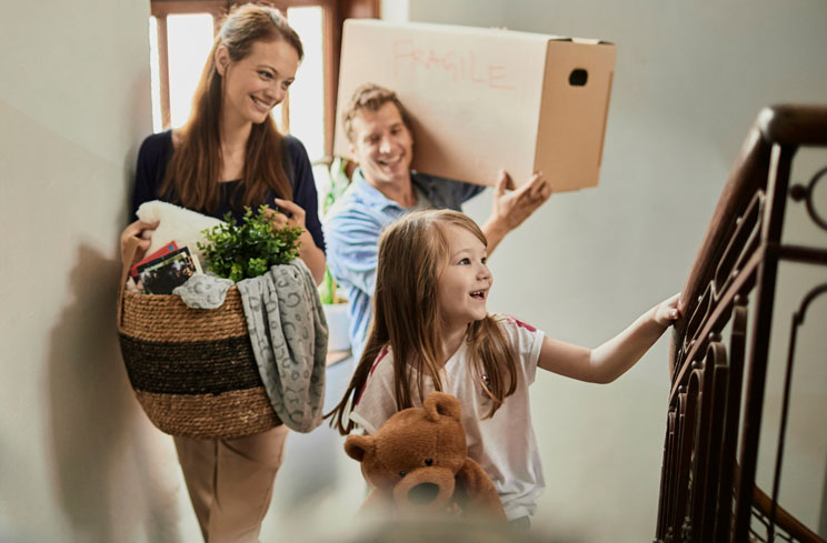 A woman, man, and child move into a new building